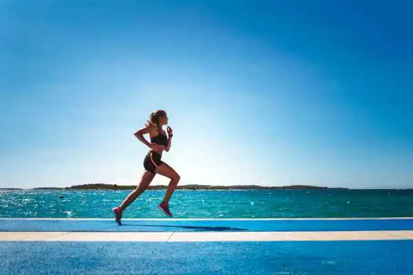 Woman running showing strong leg muscle Newham